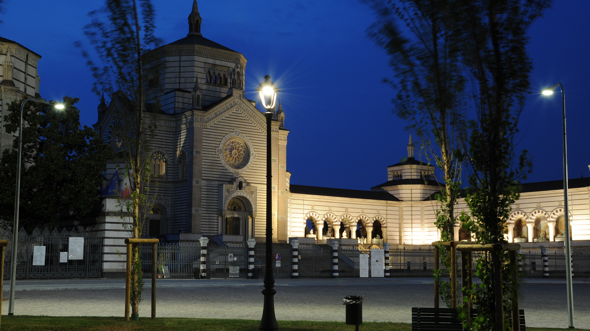 Milan (Monumental Cemetery). In the shade of cypresses and behind the tombs...